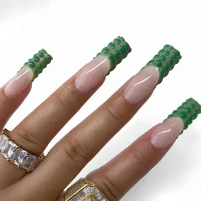 Nude nails with green on green, 3D croc tips.