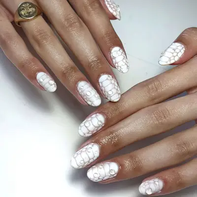 White croc print nails with water drops.