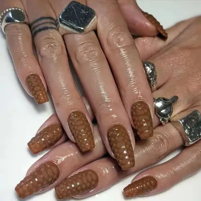 Brown croc print nails with matte scales.