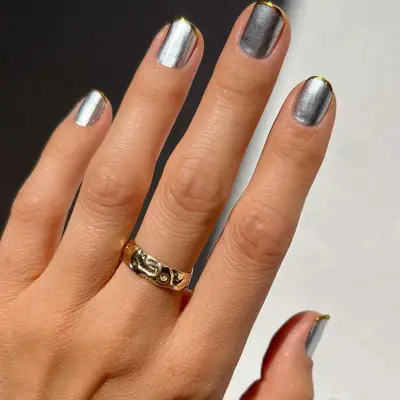 Mixed metals nails with a silver chrome base and gold chrome tips