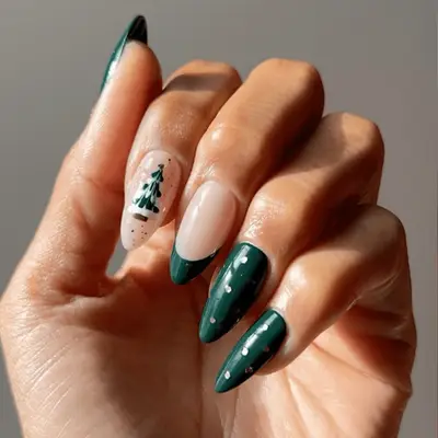 close up of hand showing off christmas manicure, nails painted bright red with small gold ribbon on each nail