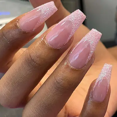 nude and pink glitter tipped french coffin nails