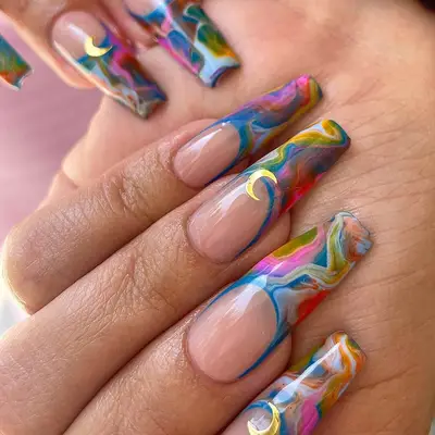 french coffin tip nails with blue, yellow, white and pink swirls and moon appliques