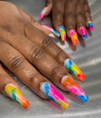 Multicolor nails with pink, blue, yellow and white.