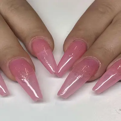 Light pink nails with glitter.