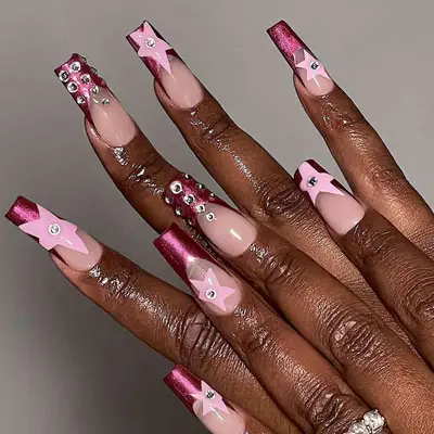 Dark pink French tips with hand painted stars and crystals.