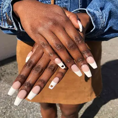 White tip french nails with heart design.
