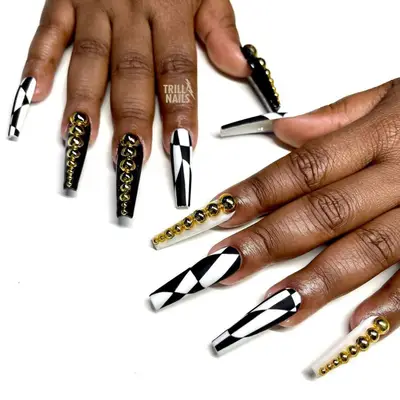 Black and white long coffin nails with gold pearls.
