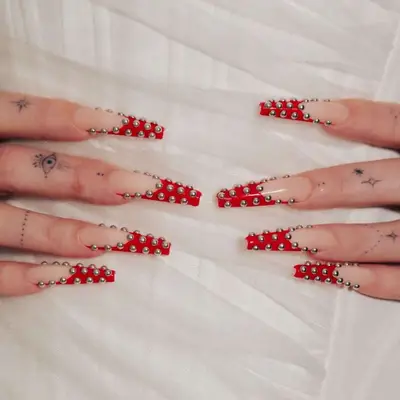 Red French-tip coffin nails with silver pearls.