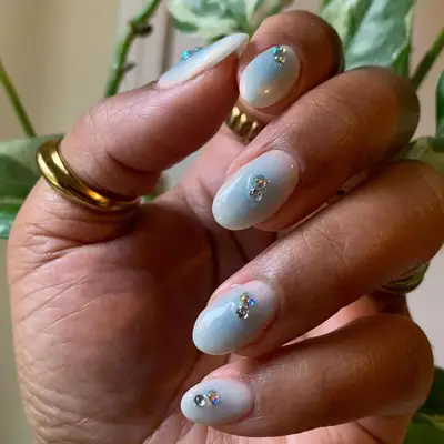 Milky White Nails with Blue Aura Centers and rhinestone acecnts
