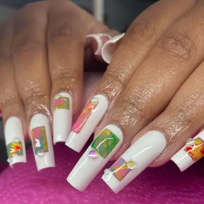 Long white square nails with colorful marble accents and iridescent dew drops