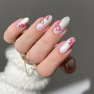 White pearlescent oval nails with pink peony nail art