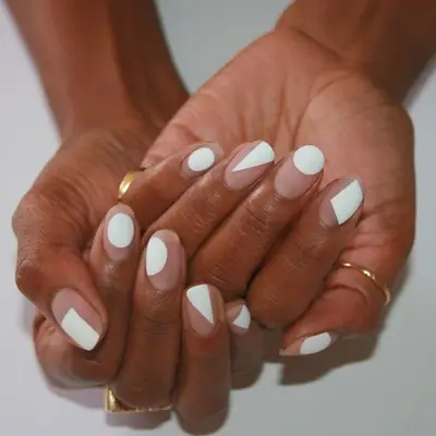 Matte white abstract negative space nail art with gold rings