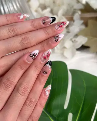 Nails with lace, bows, and berry nail art. 