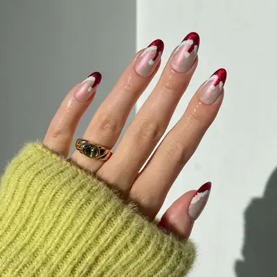 Close up of a chrome manicure with santa hat French tips
