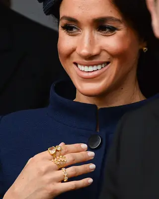 Meghan Markle in a navy blue outfit with ballerina pink nude nails