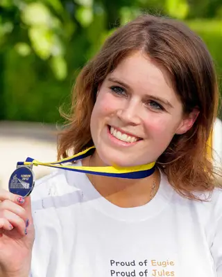 Princess Eugenie holding a medal while donning Union Jack nails