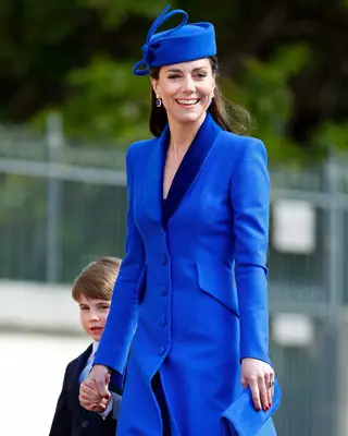 Kate Middleton in a royal blue outfit with a ruby red manicure