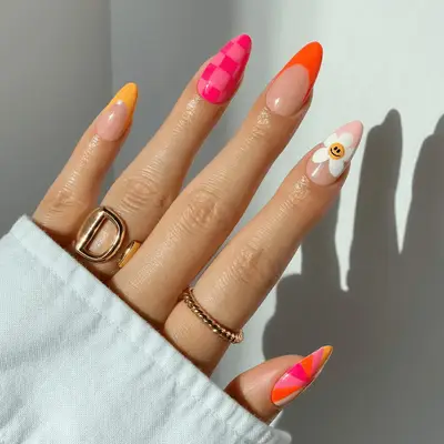 bright orange and yellow french tips with neon pink checkered accent nail