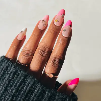 various shades of pink french tips with gold star art