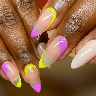 alternating neon yellow and purple asymmetrical french tips
