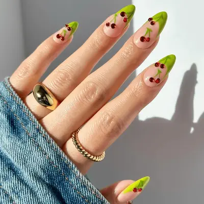 neon green french tips with 3D red cherry designs