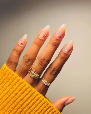Reverse French nails with flowers.