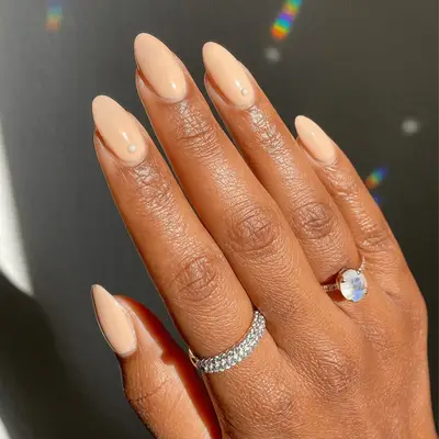 short peach nails with white pearl accent