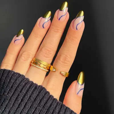 Neutral nails with blue swirls and asymmetrical gold French tips