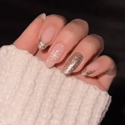 Gold chrome nails with gold swirl French designs on middle and ring finger