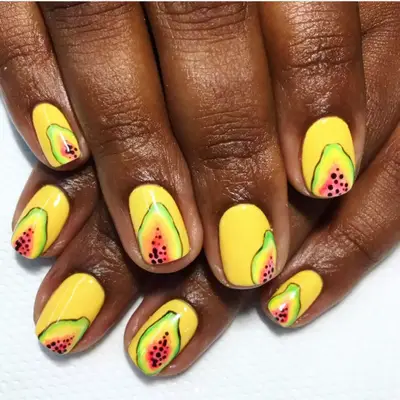 Yellow nails with papayas on each nail.