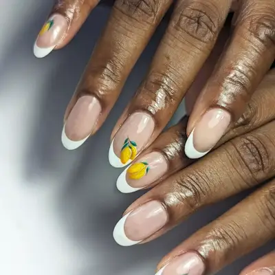 French manicure with lemon decals on three fingers.