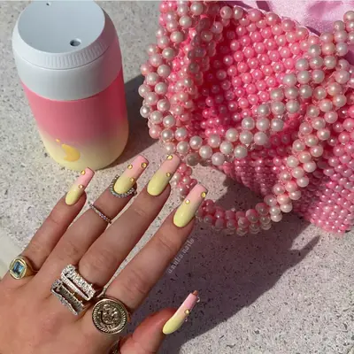 Pink to yellow ombre nail with yellow 3D bubbles.