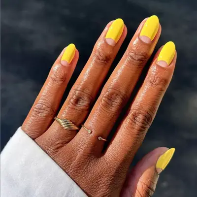 Yellow half-moon negative space manicure.