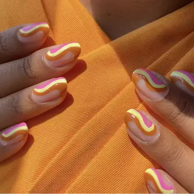 A brightly-hued manicure paired with a fun, colorful and geometric design (in this case, a 1960s-inspired swirl).