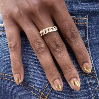 Neutral manicure with a swipe of gold foil across each nail.