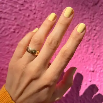 Hailey Bieber with yellow nails.