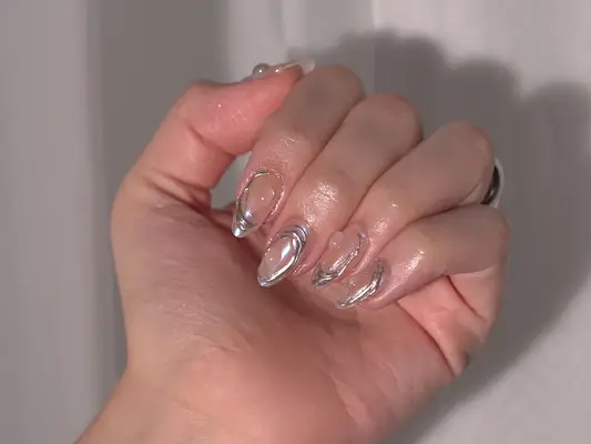 Close up of a hand with a chrome and gel blob 