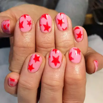 Short rounded pink nails with red stars