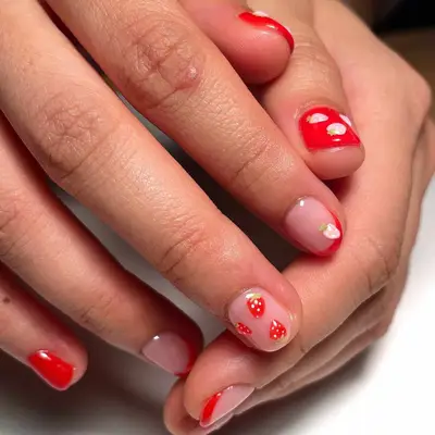 red nails with strawberry nail art