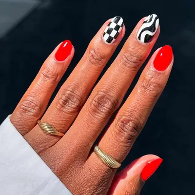 red nails with black and white design detailing