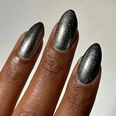 a deep silver manicure seen in close-up