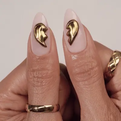 neutral base nails with gold chrome broken heart designs