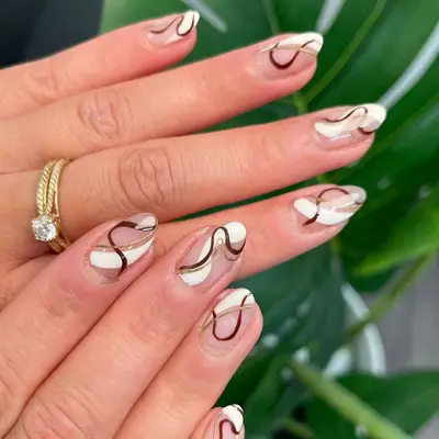 Abstract Neutral Swirl Nails in shades of white, brown, and gold