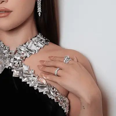 Selena Gomez pink manicure against her black and diamond dress