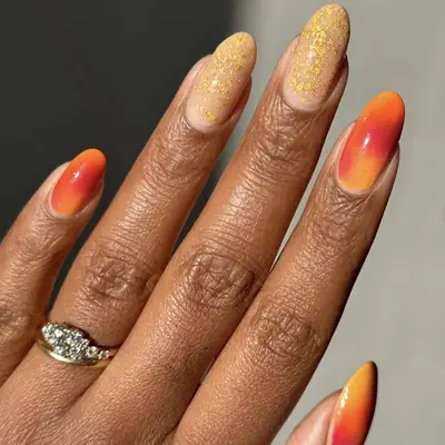 orange ombré nails and golden accent nails