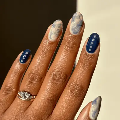 earthy green nails with white leaves accent nails