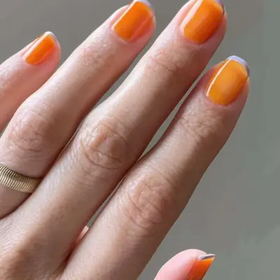 A tangerine jelly manicure with lavender French micro tips