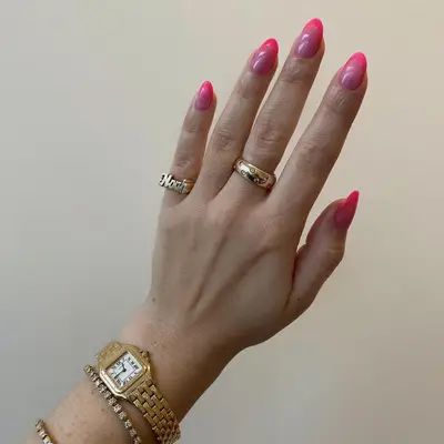 A two-toned hot pink jelly French manicure