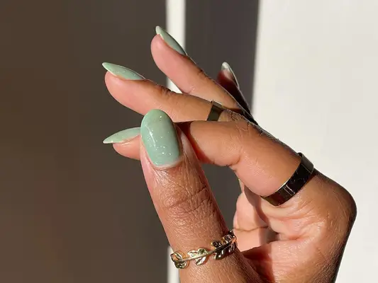 A green glitter jelly manicure 